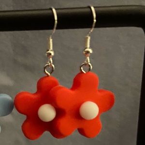 Red rubber flower earrings.